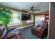 Cozy living room filled with natural light features two leather couches and a ceiling fan at 878 Abbott Ave, Deltona, FL 32725