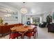 Mid century modern dining room with wood table and chairs, and view to living room at 951 Torchwood Dr, Deland, FL 32724