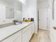 Guest bathroom with single vanity, white cabinets, and granite countertop at 962 Compass Landing Dr, Orange City, FL 32763