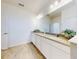Bathroom with double vanity, white cabinets, and granite countertop at 962 Compass Landing Dr, Orange City, FL 32763