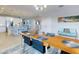 Bright dining room featuring a large table, chandelier, and kitchen views at 962 Compass Landing Dr, Orange City, FL 32763