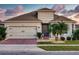 Exterior view of a single-Gathering house with a gray facade and a brick driveway at 962 Compass Landing Dr, Orange City, FL 32763