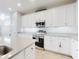 Modern kitchen with white cabinets, stainless steel appliances, and granite countertops at 962 Compass Landing Dr, Orange City, FL 32763