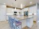 Modern kitchen with white cabinets, large island, and stainless steel appliances at 962 Compass Landing Dr, Orange City, FL 32763