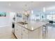 Spacious kitchen with white cabinets, stainless steel appliances, and large island at 962 Compass Landing Dr, Orange City, FL 32763