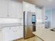 Modern kitchen with white cabinets and a stainless steel refrigerator at 962 Compass Landing Dr, Orange City, FL 32763