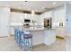 Open concept kitchen with island seating, stainless steel appliances, and white cabinetry at 962 Compass Landing Dr, Orange City, FL 32763