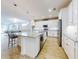 Modern kitchen with white cabinets, large island, and stainless steel appliances at 962 Compass Landing Dr, Orange City, FL 32763
