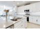 Modern kitchen with white cabinets, stainless steel appliances, and a large island at 962 Compass Landing Dr, Orange City, FL 32763