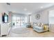 Relaxing living room featuring a light blue sectional sofa and access to backyard at 962 Compass Landing Dr, Orange City, FL 32763