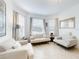 Living room with light beige sofas and large windows providing ample natural light at 962 Compass Landing Dr, Orange City, FL 32763