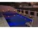 Inviting pool with fire bowls and lighting at night at 962 Compass Landing Dr, Orange City, FL 32763