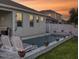 Relaxing pool area with lounge chairs and fire bowls at sunset at 962 Compass Landing Dr, Orange City, FL 32763