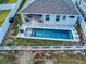 Aerial view of a home with a refreshing pool, spacious patio, and fenced backyard at 962 Compass Landing Dr, Orange City, FL 32763