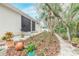 Landscaped backyard with stone pathway, mulch, and various plants at 123 Ponce Terrace Cir, Ponce Inlet, FL 32127