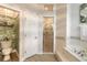 Bathroom with shower, separate toilet, and decorative wallpaper at 123 Ponce Terrace Cir, Ponce Inlet, FL 32127