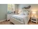 Bedroom with a white queen bed and coastal-themed decor at 123 Ponce Terrace Cir, Ponce Inlet, FL 32127