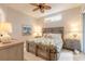 Bright bedroom featuring a king-size bed and ceiling fan at 123 Ponce Terrace Cir, Ponce Inlet, FL 32127