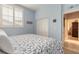 Bedroom with a queen bed, white dresser, and coastal decor at 123 Ponce Terrace Cir, Ponce Inlet, FL 32127
