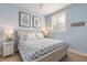 Light blue bedroom with a queen-size bed and coastal-themed decor at 123 Ponce Terrace Cir, Ponce Inlet, FL 32127