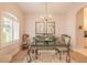 Bright dining room with a glass-top table and chandelier at 123 Ponce Terrace Cir, Ponce Inlet, FL 32127