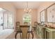 Bright dining room featuring a glass-top table, chandelier, and built-in hutch at 123 Ponce Terrace Cir, Ponce Inlet, FL 32127