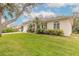 House exterior showcasing landscaping and a partial view of the driveway at 123 Ponce Terrace Cir, Ponce Inlet, FL 32127