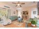 Spacious living room with light teal sofas, a unique coffee table, and built-in entertainment center at 123 Ponce Terrace Cir, Ponce Inlet, FL 32127