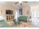 Spacious living area featuring teal sofas and a large flat-screen TV at 123 Ponce Terrace Cir, Ponce Inlet, FL 32127
