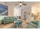 Open living room showcasing teal sofas and a coastal-themed coffee table at 123 Ponce Terrace Cir, Ponce Inlet, FL 32127