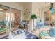 Relaxing screened porch with wicker furniture and view of backyard at 123 Ponce Terrace Cir, Ponce Inlet, FL 32127