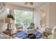 Relaxing sunroom with wicker furniture and tranquil garden view at 123 Ponce Terrace Cir, Ponce Inlet, FL 32127