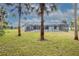 Large backyard with pool and tropical trees at 130 Old Sunbeam Dr, South Daytona, FL 32119