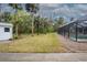 Backyard with pool, shed, and tropical landscaping at 130 Old Sunbeam Dr, South Daytona, FL 32119