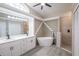 Elegant bathroom featuring a soaking tub and double vanity at 130 Old Sunbeam Dr, South Daytona, FL 32119