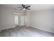Spacious bedroom with ceiling fan and wood-look tile flooring at 130 Old Sunbeam Dr, South Daytona, FL 32119
