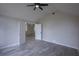 Bedroom features tile floor, a ceiling fan, and ensuite bathroom at 130 Old Sunbeam Dr, South Daytona, FL 32119