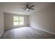 Large bedroom with ceiling fan and grey tile floors at 130 Old Sunbeam Dr, South Daytona, FL 32119