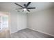 Bedroom with ceiling fan, double-door closet, and grey wood-look tile floor at 130 Old Sunbeam Dr, South Daytona, FL 32119