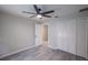 Bedroom features tile floor, a ceiling fan, and a closet with louvered doors at 130 Old Sunbeam Dr, South Daytona, FL 32119