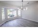 Dining room features a large window and a modern chandelier at 130 Old Sunbeam Dr, South Daytona, FL 32119