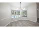 Dining room with chandelier, large windows overlooking the pool, and grey tile floor at 130 Old Sunbeam Dr, South Daytona, FL 32119