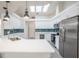 Bright kitchen features a skylight, white cabinets, quartz countertops, and stainless steel appliances at 130 Old Sunbeam Dr, South Daytona, FL 32119