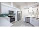 White kitchen features stainless steel appliances, quartz countertops and tile backsplash at 130 Old Sunbeam Dr, South Daytona, FL 32119
