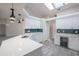 Bright kitchen features a skylight, white cabinets, quartz countertops, and stainless steel appliances at 130 Old Sunbeam Dr, South Daytona, FL 32119