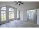 Living room featuring soaring vaulted ceilings, an abundance of natural light from large windows, and plank flooring at 130 Old Sunbeam Dr, South Daytona, FL 32119
