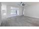 Open living space with plank flooring, high ceilings, and a glass sliding door leading to a screened outdoor area at 130 Old Sunbeam Dr, South Daytona, FL 32119