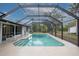 Relaxing screened-in pool area with a spacious deck at 130 Old Sunbeam Dr, South Daytona, FL 32119