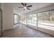Spacious screened porch with pool view and grey tile floor at 130 Old Sunbeam Dr, South Daytona, FL 32119