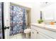 Bright bathroom with a fish-themed shower curtain and white vanity at 1413 La Paloma Cir, Winter Springs, FL 32708
